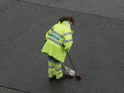 Una trabajadora barre una calle de Madrid.