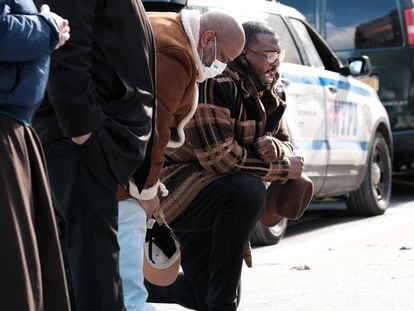 Los miembros del clero local, incluido el pastor Kevin McCall (derecha), se reúnen para una vigilia y oran frente a un edificio de apartamentos en el Bronx.