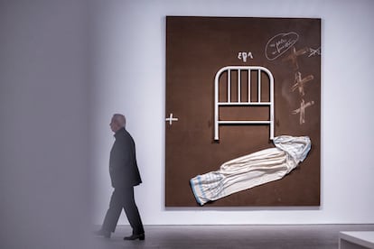 Un hombre camina cerca de una obra durante la presentación de la gran exposición dedicada a Antoni Tàpies.