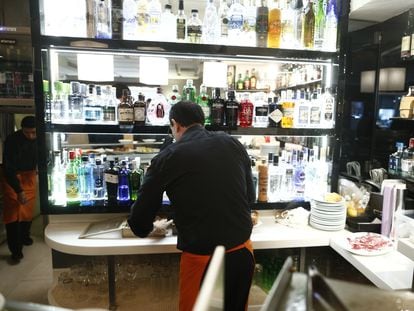 Un camarero atiende la barra en un bar de Madrid.