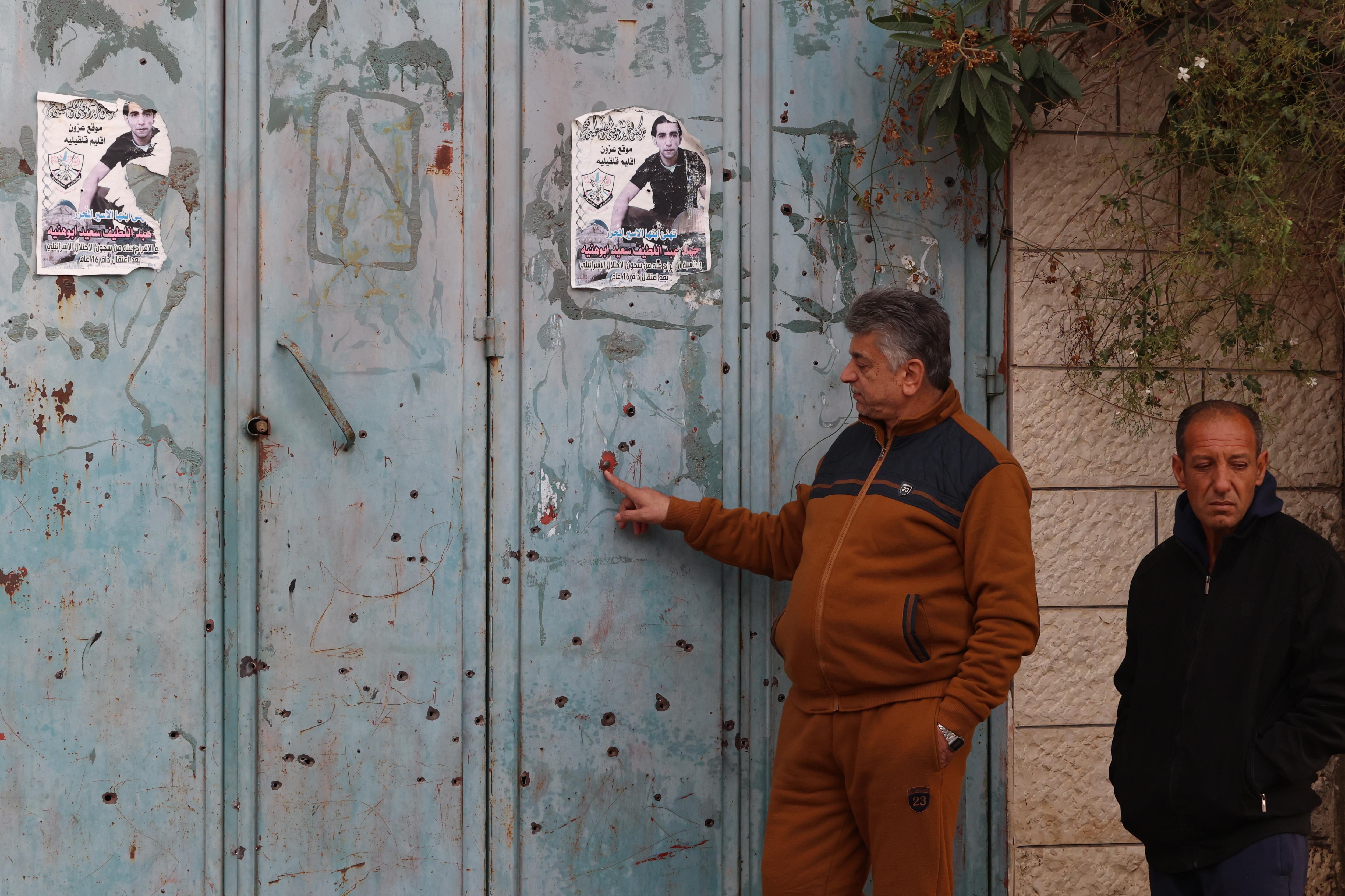 Qalqilya (-), 02/01/2024.- Palestinians look at bullet impacts near at the location where four Palestinians were killed following an Israeli army raid at Azoun village Near Qalqilya, West Bank, 02 January 2024. According to the Palestinian Health Ministry on 02 Januray, at least four people were killed following an Israeli army raid at Azoun Village in the West Bank. EFE/EPA/ALAA BADARNEH 