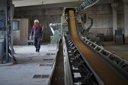 Engineer Oleksandr Mironenko stands next to one of the Mlybor barn's conveyor belts in Chernihiv on Thursday.