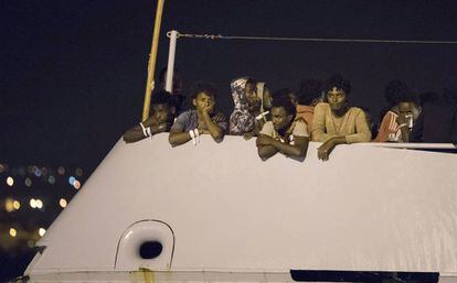 Un grupo de migrantes a bordo de una nave de Frontex a punto de atracar en Pozzallo (Sicilia).