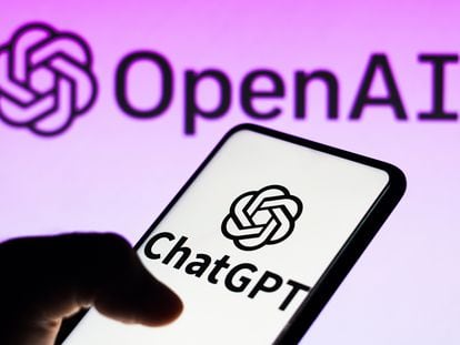 In this photo illustration, the ChatGPT logo is seen displayed on a smartphone and the OpenAI company logo on background