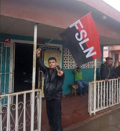 According to local media, a young man waves a Sandinista flag in front of the Pantasma mayor's office, pictured on July 2.