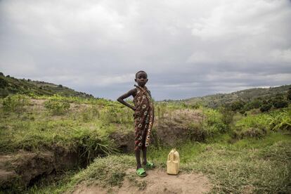 Hace 25 años Mutete pagó un alto precio por la locura sanguinaria de los genocidas hutus. Más de 1.000 habitantes de esta localidad murieron en el genocidio que, según la ONU, causó al menos 800.000 muertos, sobre todo entre la minoría tutsi, entre abril y julio de 1994. Ahora las dos aldeas están aprendiendo a convivir nuevamente, compartiendo todo lo que tienen, incluido el agua, como lo habian hecho antes del genocidio de 1994. En la imagen, una niña toma agua de un manantial en el valle que separa las aldeas de Musambira y Nyarubaka, en el distrito de Kamonyi, en el sur de Ruanda.