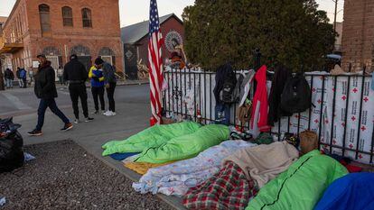 Migrantes duermen en la acera la mañana de este lunes en El Paso, un día después de la visita de Biden.