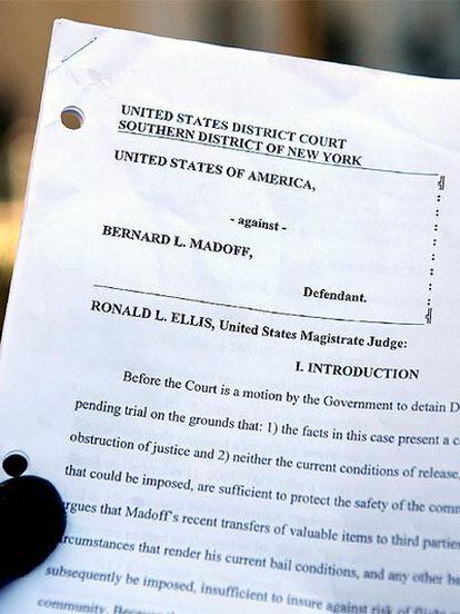 Un periodista sostiene en las inmediaciones de la Corte Federal la orden del juez que mantiene el arresto domiciliario para Madoff