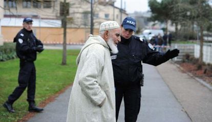 Un policía pide a un hombre que se aleje de la mezquita atacada en Mans.