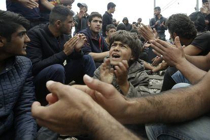 inmigrantes y refugiados gritan "abran las fronteras" en un campamento del norte de Grecia.