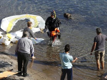 Un guardacostas traslada el cadáver de un niño tras el naufragio.