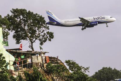 Un avi&oacute;n de IndiGo sobrevuela una zona cercana al aeropuerto de Bombai (India)
