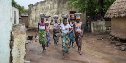 Las chicas jóvenes de Oussoubidiagna llevan en sus cabezas los platos de comida para sus padres o maridos que trabajan en los campos de alrededor.