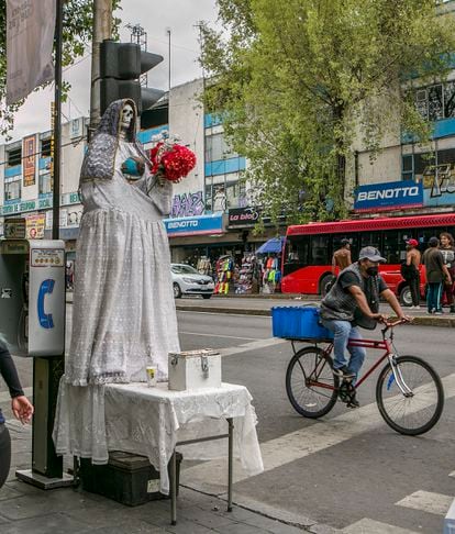 A person rides a bicycle past a shrine to Santa Muerte in the Centro Hist-rico neighborhood in Mexico City, Mexico.