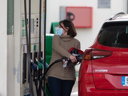 Una mujer llena el depósito de su coche, a finales de febrero, en una gasolinera de Madrid.