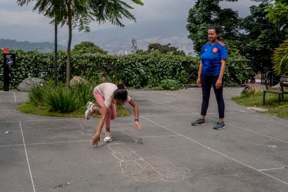 Alexandra Gutiérrez Arango y su sobrina Salomé, de nueve años, juegan a la rayuela en el parque del barrio Prado, Medellín.