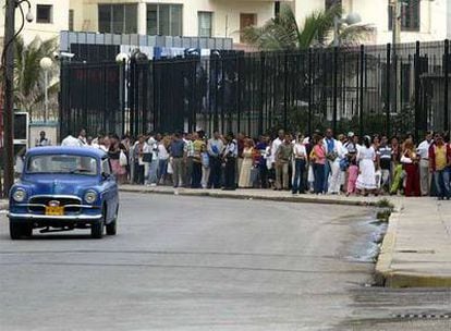 Decenas de cubanos hacen cola para conseguir un visado en el edificio de la misión de EE UU en La Habana, en junio de 2006.