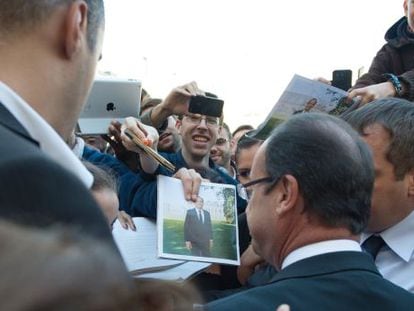 El presidente Hollande saluda a simpatizantes junto al Elíseo.