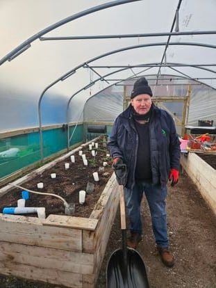 Stewart Finnley, in the greenhouse at the Shankill Road community garden.