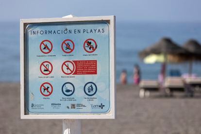 Several people enjoy themselves on the Ferrara beach in the town of Torrox, in Málaga, on August 4, 2023. Reserving space by placing umbrellas, chairs and other belongings for bathers is prohibited there.
