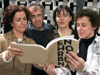 Los portavoces de la coordinadora Gesto por la Paz, Fabián Laespada e Itziar Aspuru, en el centro, ojean el libro sobre la historia de la coordinadora.