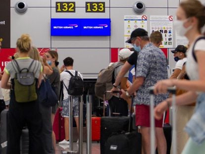 Varios viajeros hacen cola en el mostrador de un vuelo de British Airways en Mallorca, este lunes.
