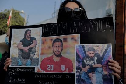 Una mujer protesta frente a la Embajada de Irán en Ciudad de México, mientras sostiene fotografías del futbolista Amir Nasr-Azadani, el 19 de diciembre.
