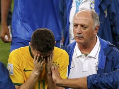 Scolari trata de animar a Oscar tras el partido.