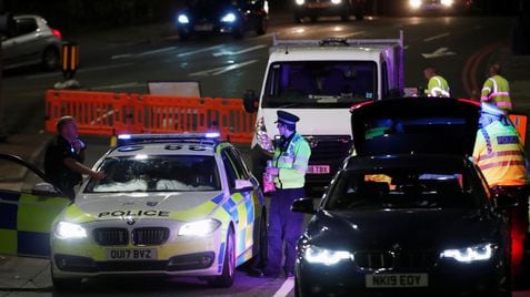 Police officers and their vehicles are seen at a cordon at the scene of reported multiple stabbings in Reading, Britain, June 20, 2020. REUTERS/Peter Cziborra