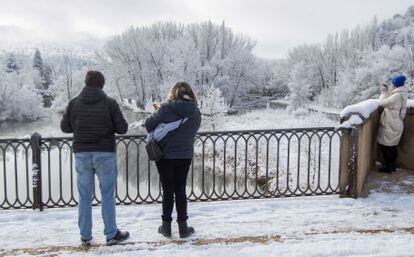 Turistas hacen fotos junto al río Duero, este viernes en Soria.