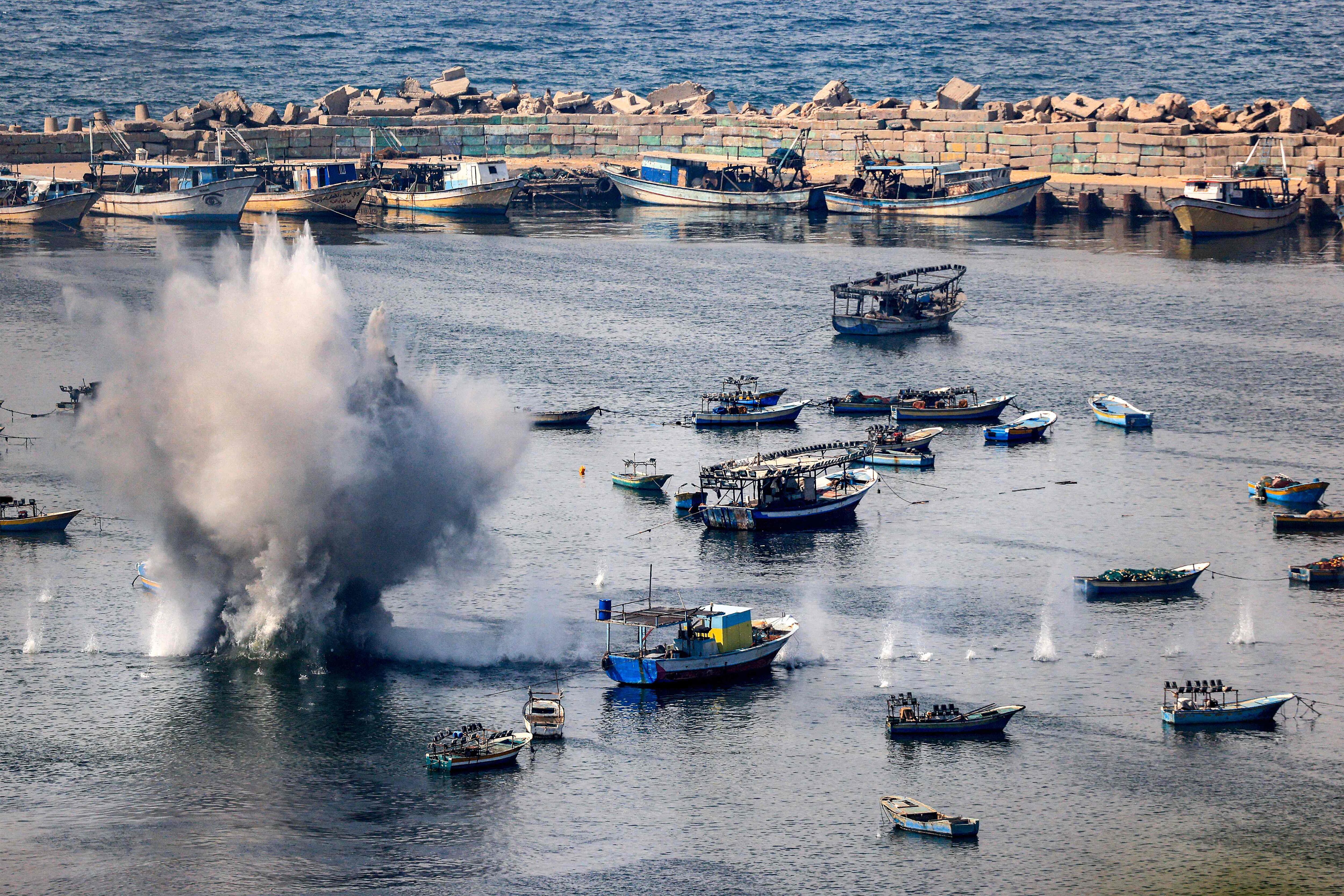 TOPSHOT - Shells from Israeli bombardment land in the water in the Gaza City seaport on October 11, 2023 on the fifth day of ferocious fighting between the Palestinian Islamist movement Hamas and Israel. Israel declared war on Hamas on October 8 following a shock land, air and sea assault by the Gaza-based Islamists. The death toll from the shock cross-border assault by Hamas militants rose to 1,200, making it the deadliest attack in the country's 75-year history, while Gaza officials reported more than 900 people killed as Israel pounded the territory with air strikes. (Photo by MAHMUD HAMS / AFP)