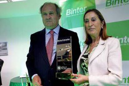 La ministra de Fomento, Ana Pastor, y el presidente de Binter Canarias, Pedro Agustín del Castillo, posan con el premio recibido recientemente a la mejor compañía aérea 2013/14 en Europa, tras inaugurar hoy las nuevas oficinas de la compañía en La Laguna (Tenerife).