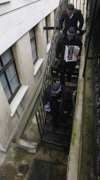 La policía entra en una casa de apartamentos de lujo en Londres.