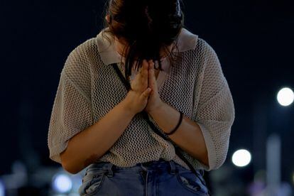 A woman cries at the site where former Japanese Prime Minister Shinzo Abe was shot at an election campaign rally on Friday.