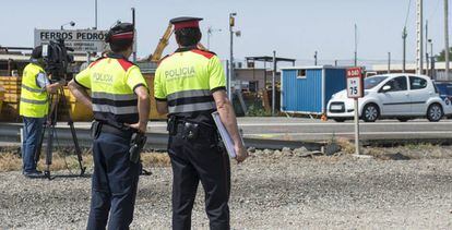 Dos 'mossos' vigilan una carretera en Juneda (Lleida).