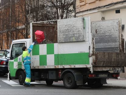 Un trabajador municipal lanza un objeto a un camión de limpieza con matrícula GZS, del 2010, este martes por el centro de Madrid.