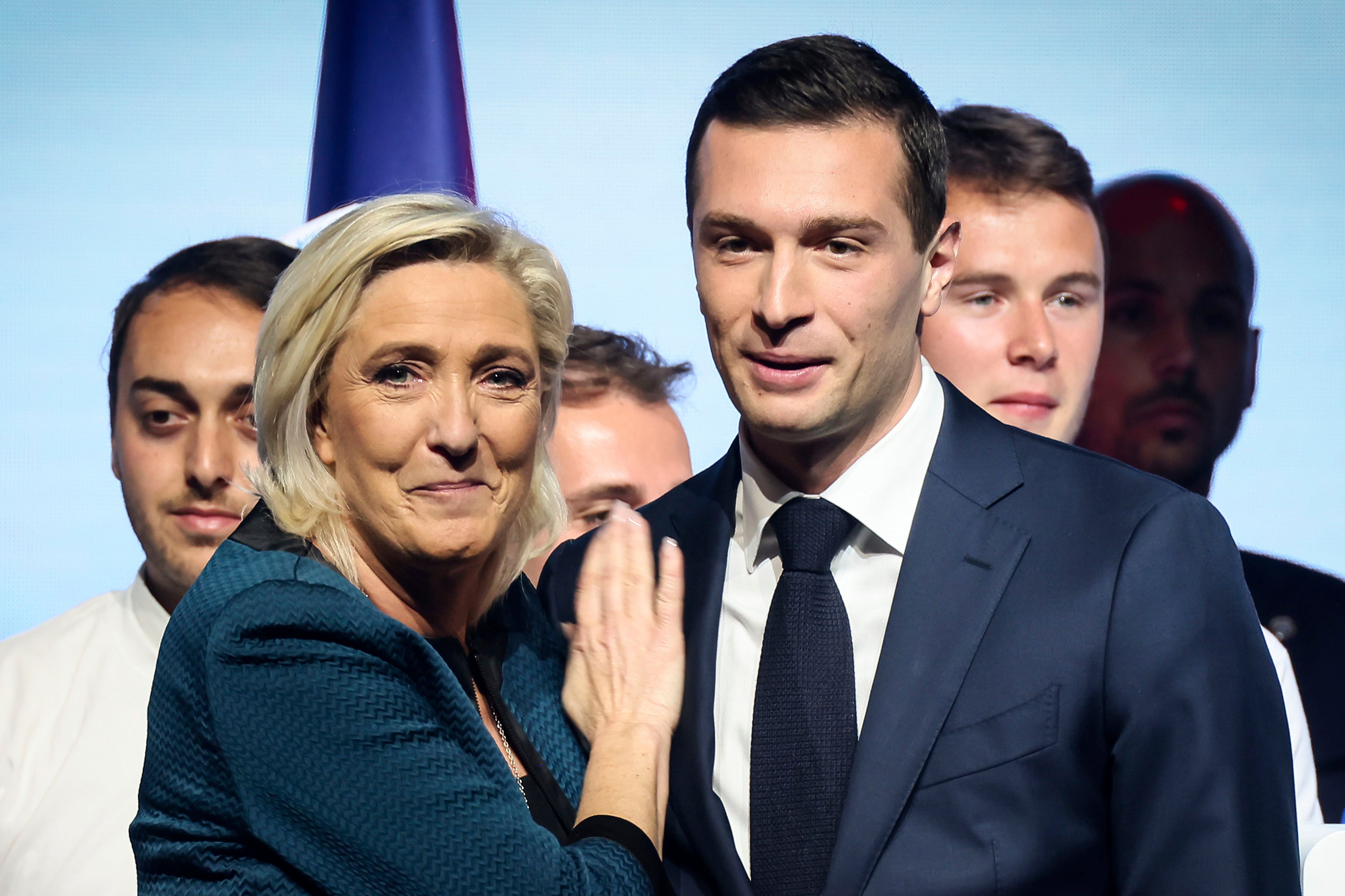 Leader of the French far-right National Rally Marine Le Pen, left, and lead candidate of the party for the upcoming European election Jordan Bardella during a political meeting on June 2, 2024 in Paris. At just 28 years old, Jordan Bardella has led the French far right to a landslide victory in the European Parliament election in June. After voters propelled Marine Le Pen's National Rally to a strong lead in the first round of national legislative elections on Sunday, Bardella has turned to rallying supporters to grant Marine Le Pen's party an absolute majority in the decisive round of voting on July 7 and make him the prime minister of France. (AP Photo/Thomas Padilla, File)