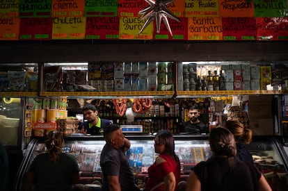 People line up to buy at a store in Caracas. 