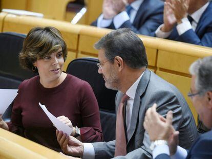 La vicepresidenta del Gobierno, Soraya Sáez de Santamaría, y el ministro de Justicia, Rafael Catalá, conversan en el Senado.