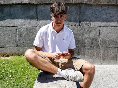 Javier González (18 años) consulta su teléfono móvil en Moncloa (Madrid).