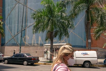 Passers-by walk in front of the Sambil de La Candelaria shopping center in Caracas, Venezuela, in March 2022.