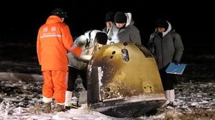 Researchers work next to Chang'e-5 lunar return capsule carrying moon samples, after it landed in northern China's Inner Mongolia Autonomous Region, December 17, 2020. China Daily via REUTERS ATTENTION EDITORS - THIS IMAGE WAS PROVIDED BY A THIRD PARTY. CHINA OUT.