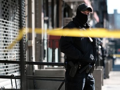 Un policía custodia el acceso al edificio donde dos agentes fueron asesinados en acto de servicio el 22 de enero, en Harlem (Nueva York).
