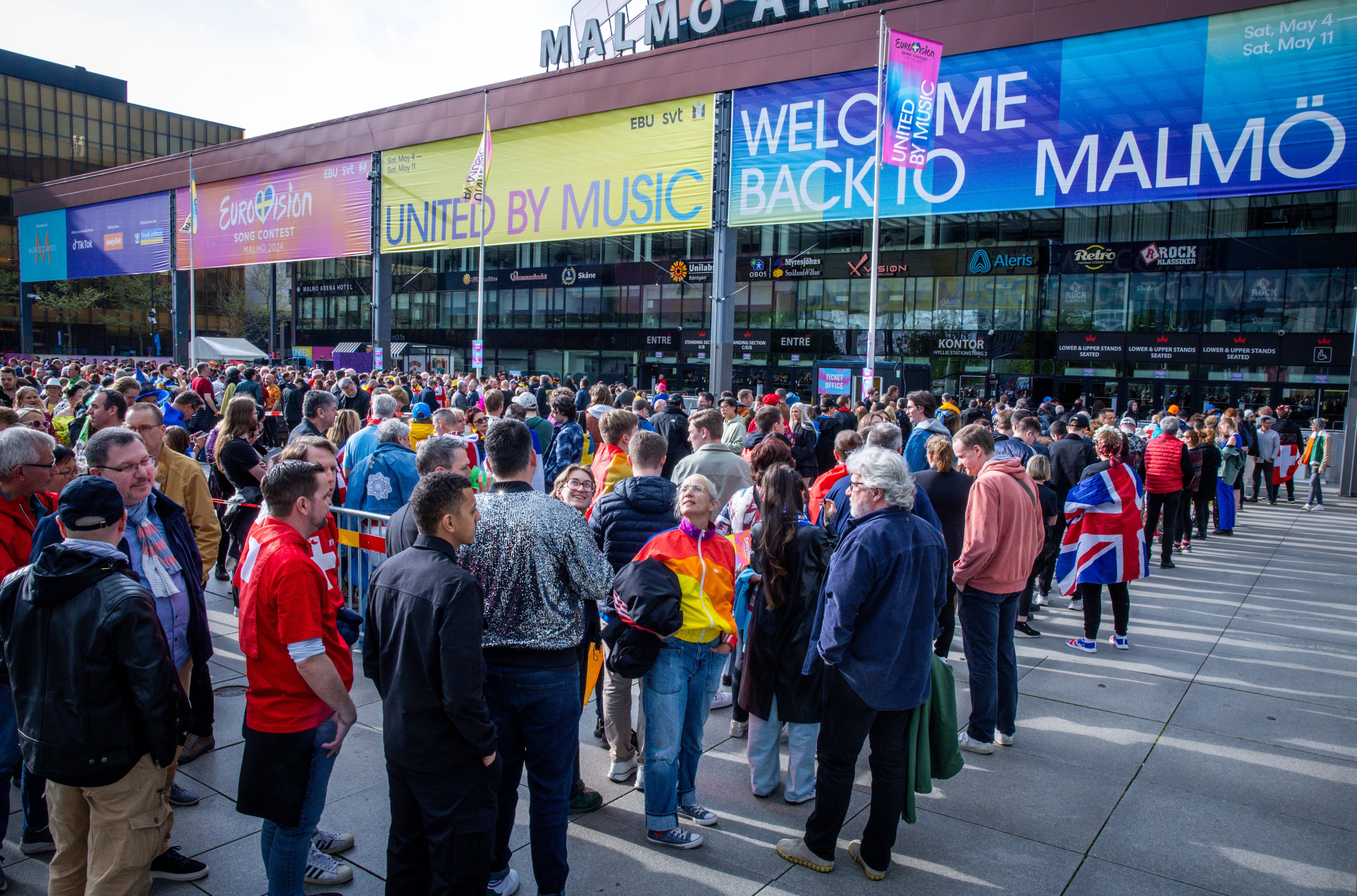 11 May 2024, Sweden, Malmö: Music fans stand outside the Malmö Arena before the start of the final of the Eurovision Song Contest (ESC) 2024 and wait to be admitted to the hall. In the world's biggest singing competition under the motto "United By Music", 25 countries will now compete in the final after the candidate from the Netherlands was officially excluded from the competition. Photo: Jens Büttner/dpa (Photo by Jens Büttner/picture alliance via Getty Images)