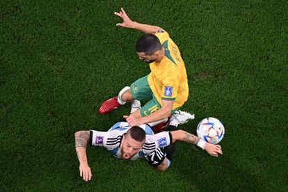 Argentine midfielder Alejandro Gómez receives a kick from Australian defender Aziz Behich.