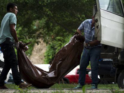 Un equipo forense recoge los cuerpos de dos asesinados en Choloma, Honduras.