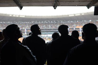 La gente asiste a la ceremonia en memoria del ex presidente Nelson Mandela en el estadio FNB en Johannesburgo.