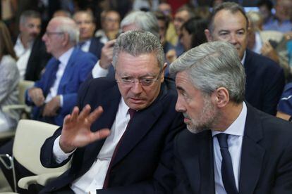 Los exministros del PP Alberto Ruiz-Gallardón (izquierda) y Ángel Acebes conversan antes del debate en el Colegio de Arquitectos de Madrid.