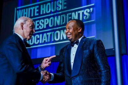 US President Joe Biden (left) chats with guest comedian Roy Wood.