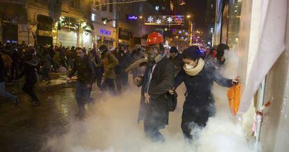 Grupos de manifestantes huyen de los gases lacrim&oacute;genos de la polic&iacute;a en el centro de Estambul, el 27 de diciembre. 